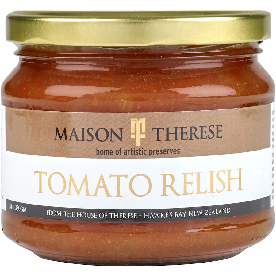 Maison Therese Tomato Relish in a jar, showcasing a thick, chunky blend of tomatoes, onions, and spices for flavorful meals.