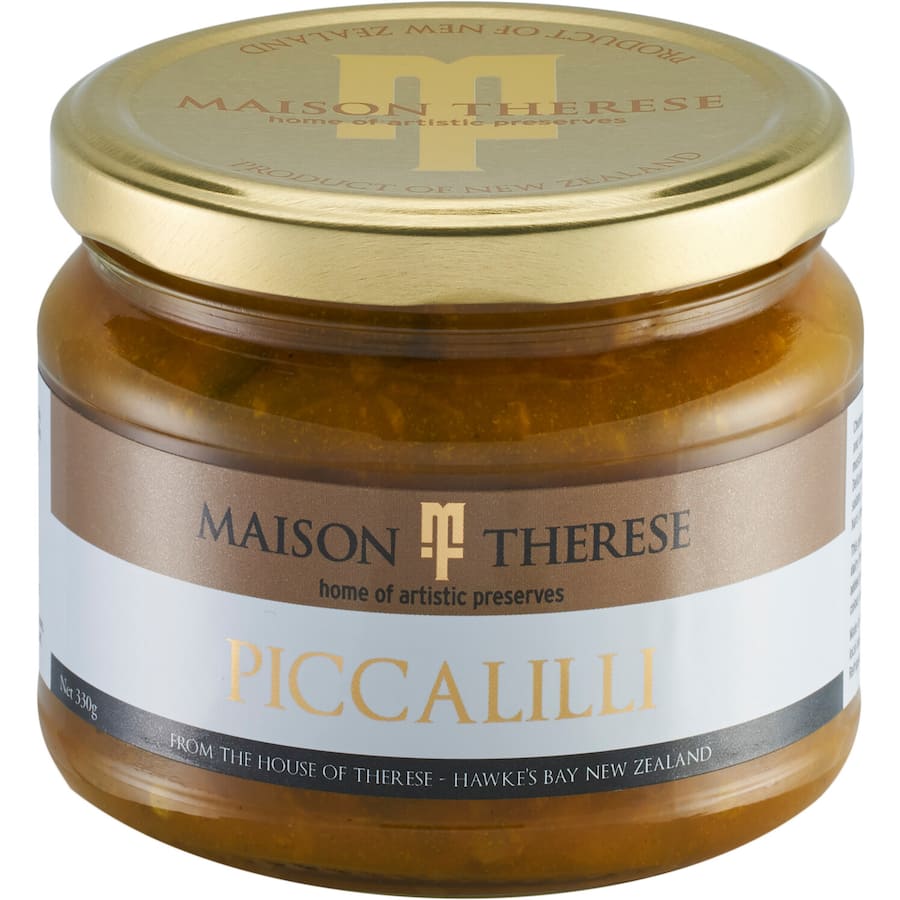 A jar of Maison Therese Piccalilli featuring chunky cauliflower, gherkins, and onions in a rich mustard turmeric sauce.