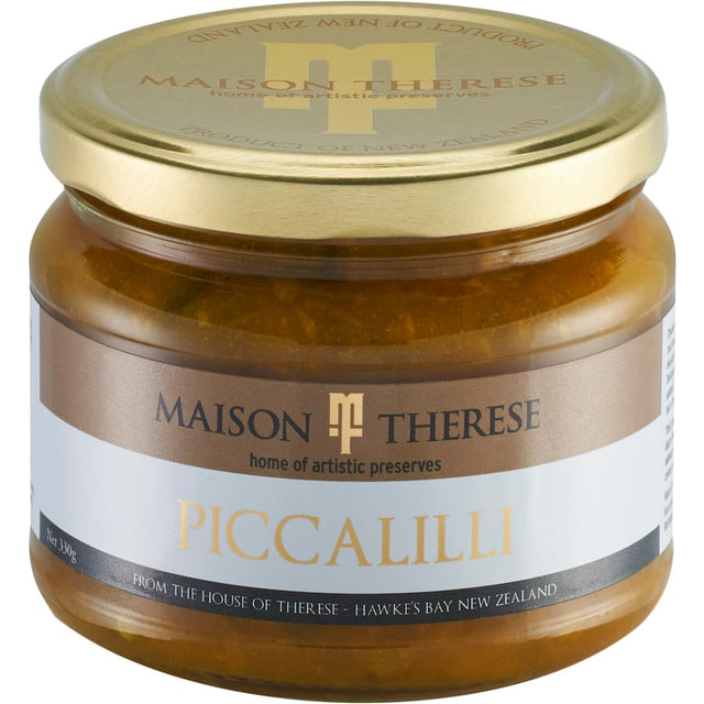 A jar of Maison Therese Piccalilli featuring chunky cauliflower, gherkins, and onions in a rich mustard turmeric sauce.