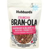 Hubbards Bran-ola Granola with raspberry and blueberry, featuring crunchy clusters, bran, coconut, almonds, and probiotics.