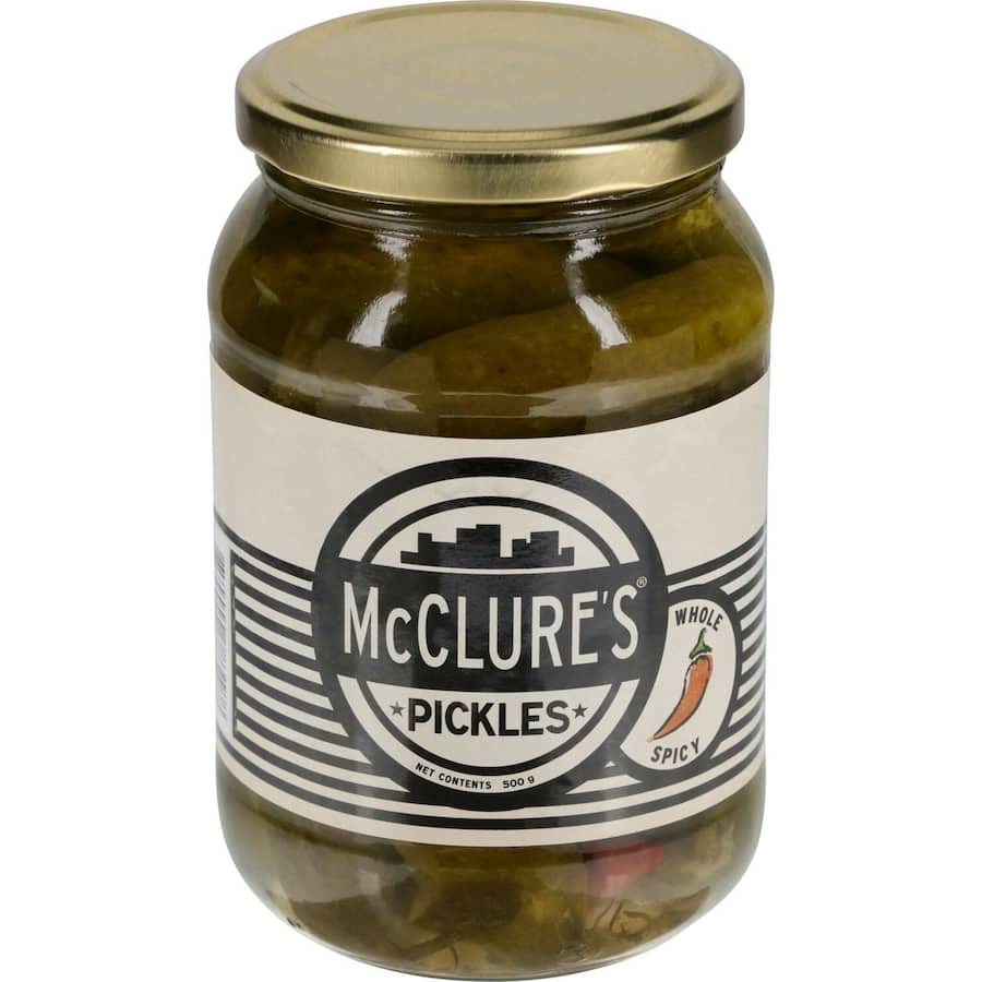 McClures Gherkins Spicy Pickles in a jar, featuring crunchy, zesty cucumbers with a secret spice blend for added heat.