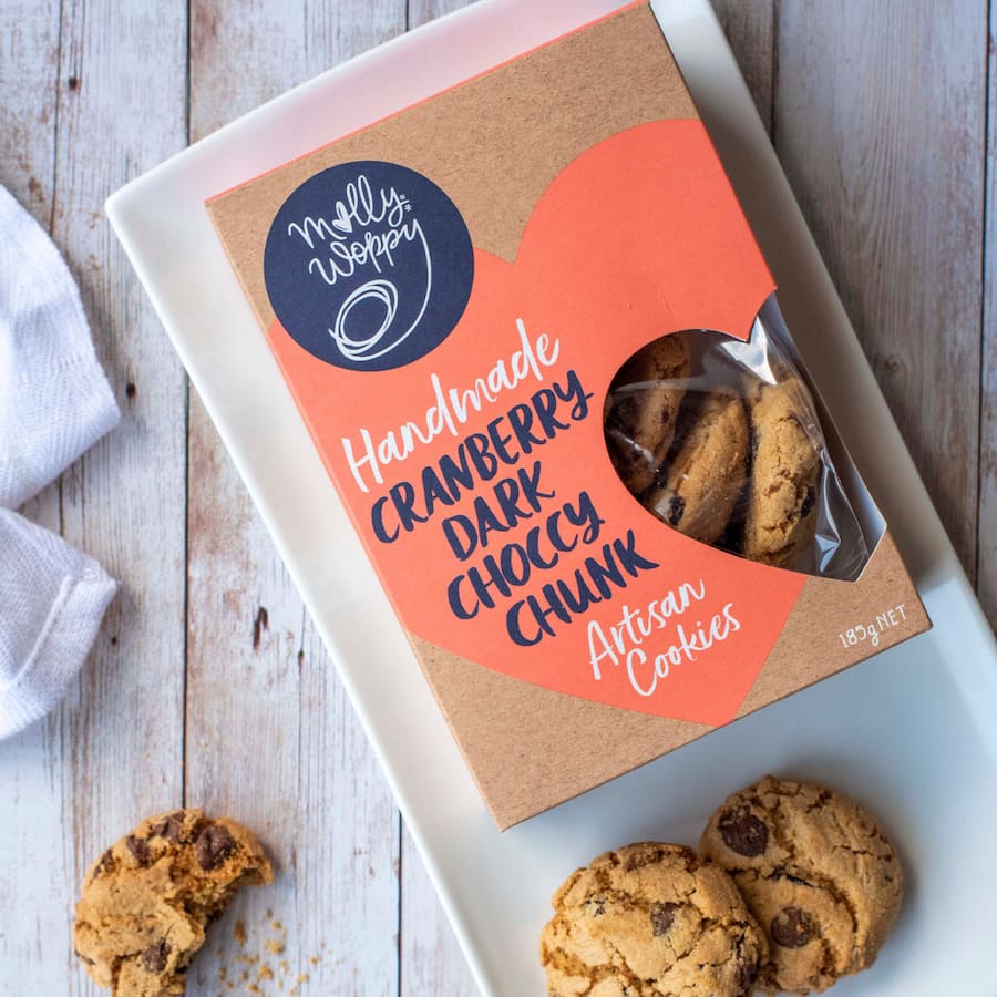 Molly Woppy Biscuits featuring cranberry and dark chocolate chunks, offering a crunchy, indulgent snacking experience.