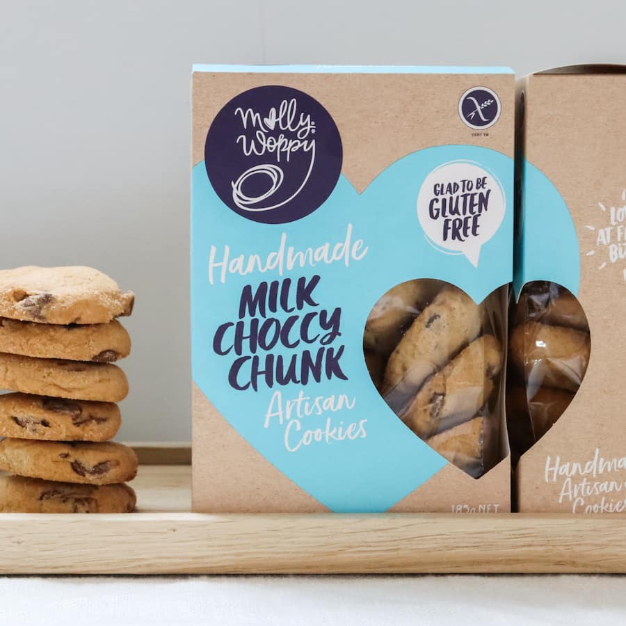 Molly Woppy Gluten Free Biscuits with rich milk chocolate chunks, perfect for gluten-conscious snackers seeking indulgence.