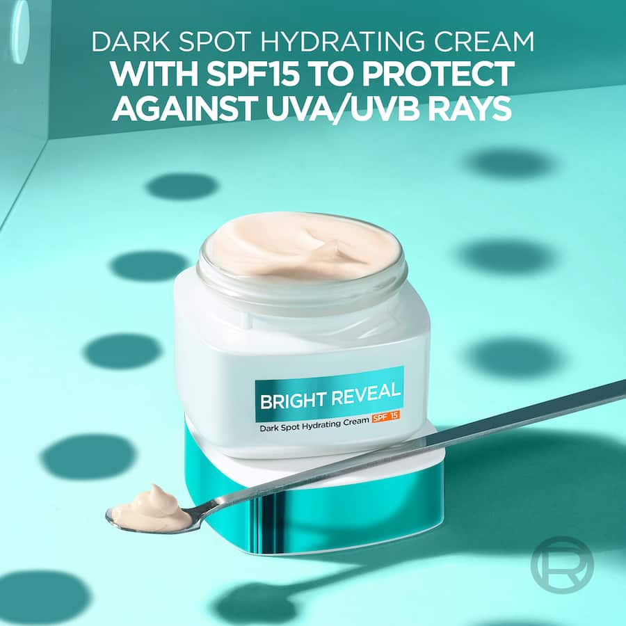 L'Oréal Bright Reveal Dark Spot Cream SPF 15, featuring Niacinamide for brightening and hydration, protects skin from UV rays.