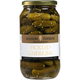 A jar of Maison Therese Gherkins, featuring plump, crunchy pickles in tangy vinegar with spices, perfect for gourmet dishes.