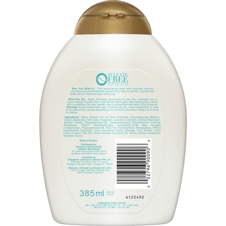 Hydrating OGX Quenching + Coconut Curls Shampoo enhances defined curls with coconut oil, honey, and citrus for frizz-free shine.