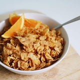 Bowl of Kellogg's Corn Flakes with crisp, light flakes made from sun-ripened corn, perfect for a nutritious breakfast.