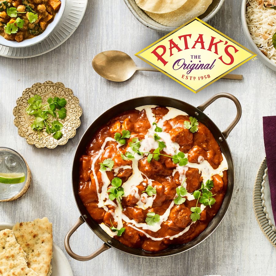 Patak's Simmer Sauce Butter Chicken Spicy in a glass jar, featuring creamy tomato and aromatic spices for quick, flavorful meals.