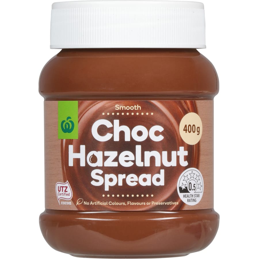 Woolworths Hazelnut Spread in a jar, showcasing rich hazelnuts blended for a creamy, delectable chocolate topping.