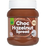 Woolworths Hazelnut Spread in a jar, showcasing rich hazelnuts blended for a creamy, delectable chocolate topping.