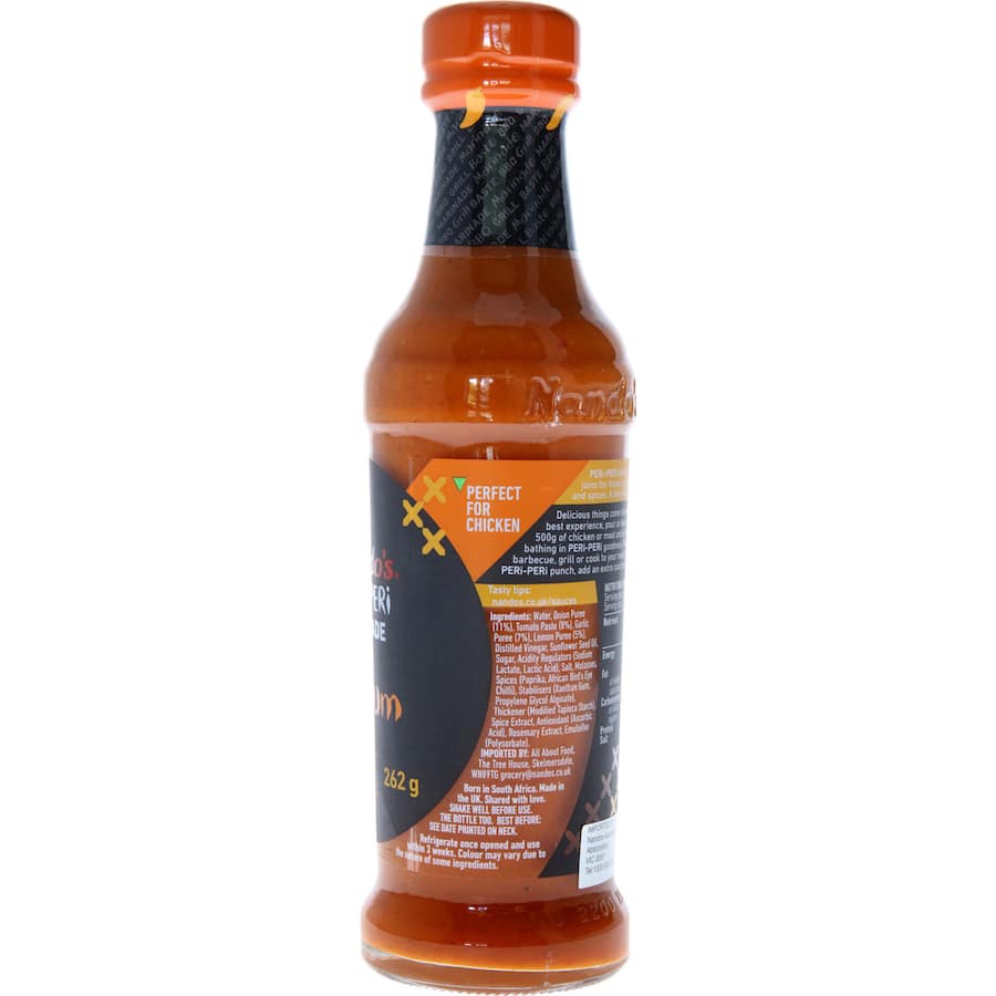 Nandos Peri Peri Marinade Medium bottle showcasing its vibrant sauce, perfect for marinating chicken, meats, and vegetables.