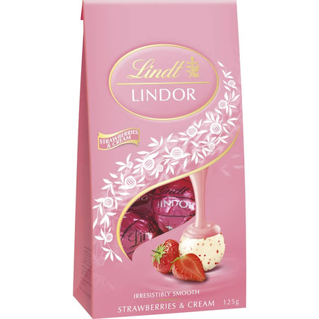 Lindt Lindor Strawberries & Cream truffles feature a smooth strawberry filling in a rich white chocolate shell, perfect for sharing.