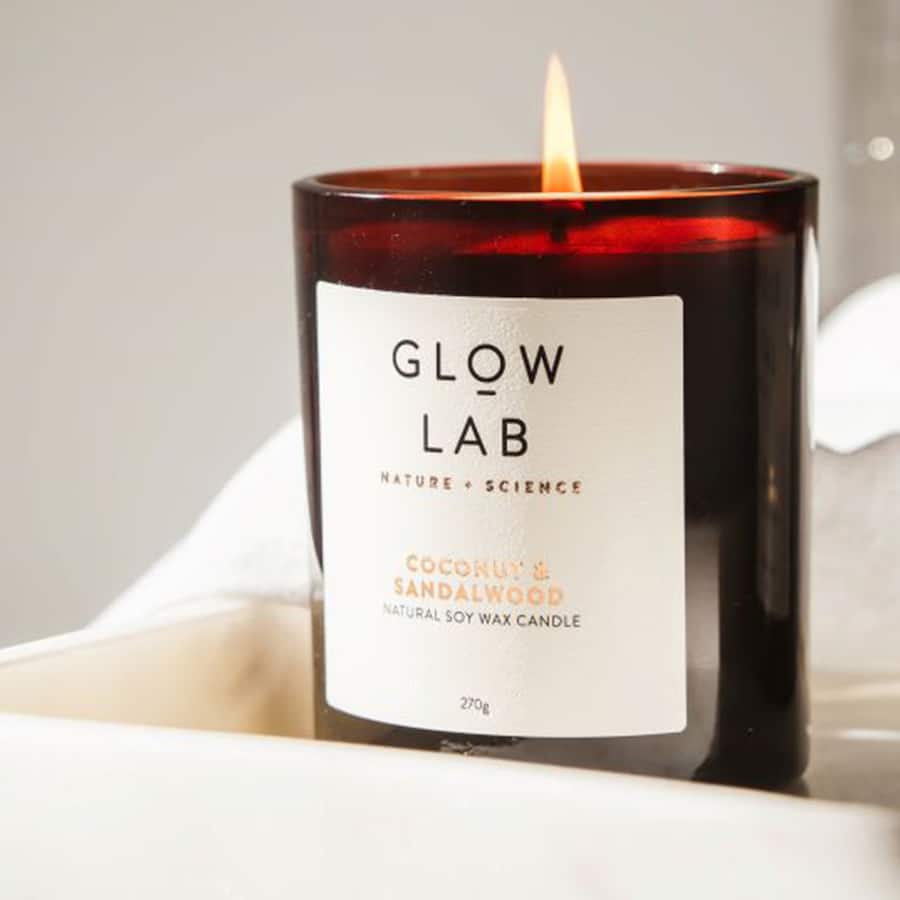 Glow Lab Scented Candle in dark glass, featuring coconut and sandalwood aroma, perfect for relaxation with a 40-60 hour burn time.