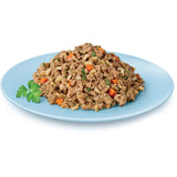 Wet puppy food in a 100g tray featuring chicken, rice, carrots, and spinach for balanced nutrition and growth.