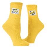 Blue Q Tag Socks in Large/Extra-Large feature witty designs, cushioned comfort, and organic cotton for a stylish and fun look.