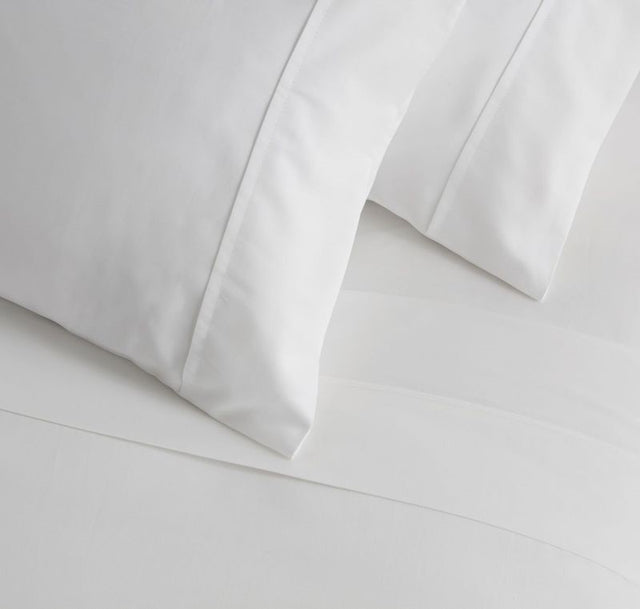 Luxurious white 500TC sateen cotton sheet set by Baksana, including flat, fitted sheet, and pillowcase for a silky sleep.