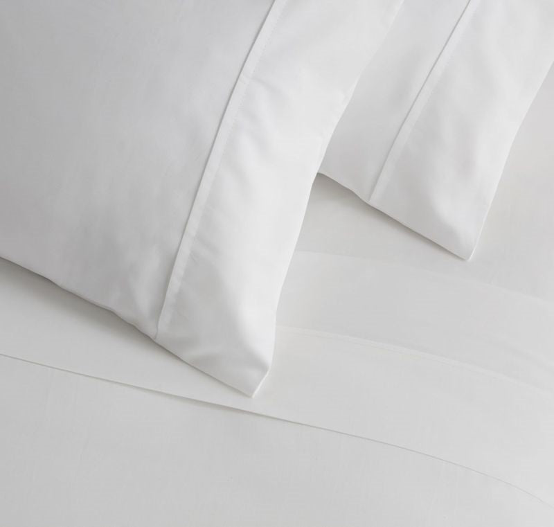 Luxurious Baksana 500TC white cotton sateen sheet set for King Single, featuring a flat sheet, fitted sheet, and pillowcases.