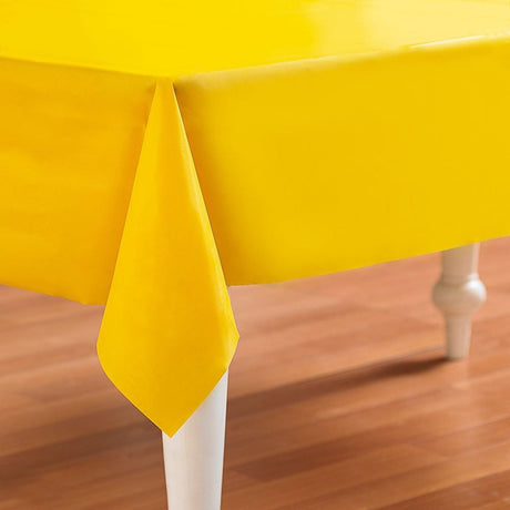 Bright yellow table cover, 54" x 108", durable plastic for events, easy cleanup, vibrant addition for any gathering.