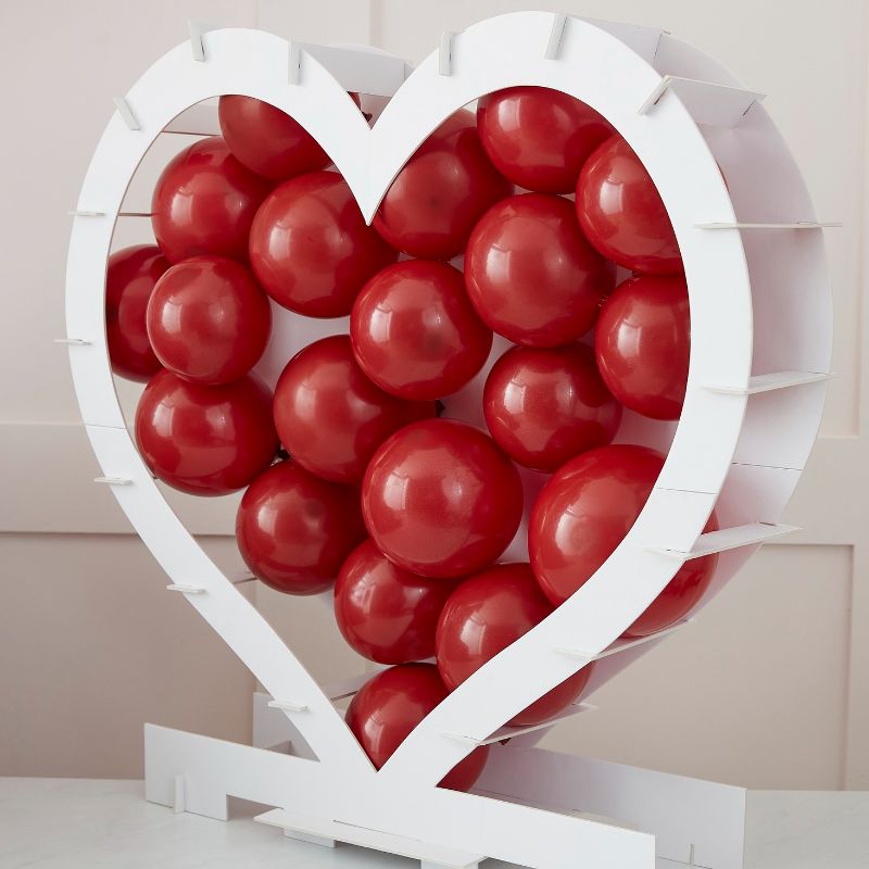 Heart-shaped balloon mosaic stand, perfect for romantic celebrations; easy to assemble, eco-friendly, and customizable with balloons.