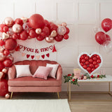 Heart-shaped balloon mosaic stand for romantic occasions, easy to assemble, eco-friendly with biodegradable balloons.