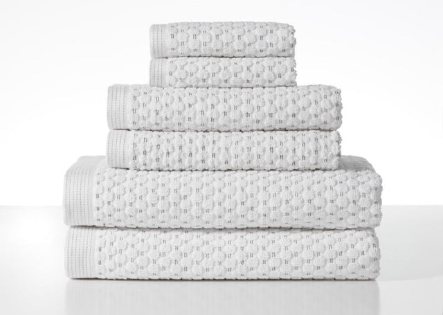 Henley Optic White Towel Bundle by BAKSANA, featuring 2 bath towels, 2 hand towels, and 2 facecloths, all in pure cotton.