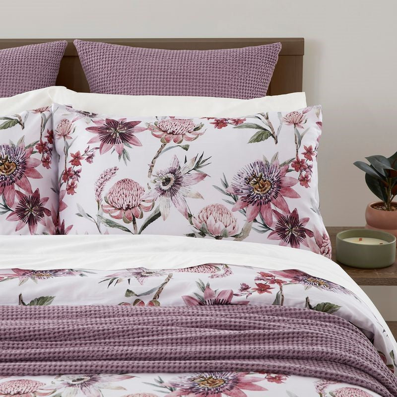 Duvet cover set featuring a protea print on lilacberry, made of 100% cotton sateen, ethically produced by BAKSANA.