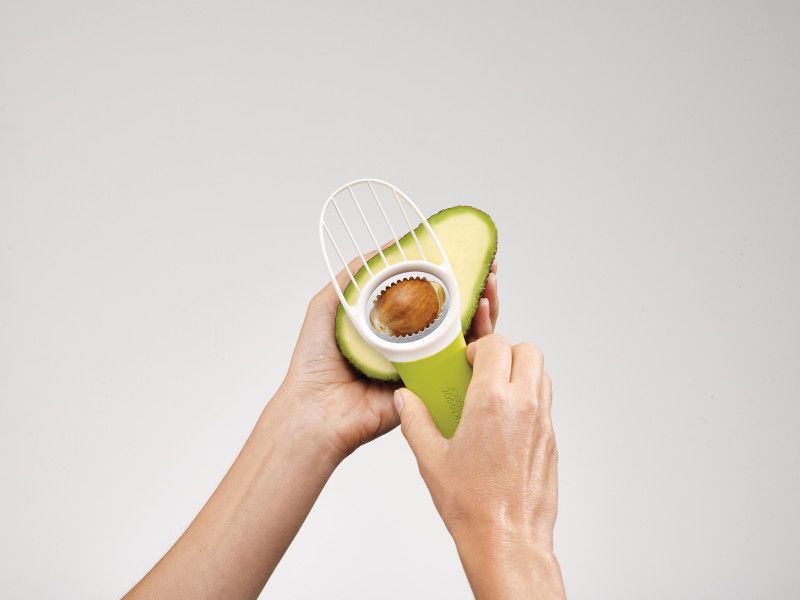 Ergonomic avocado tool with folding blade, stainless-steel pitter, and versatile slicing head for easy preparation.