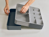 Joseph Joseph DrawerStore organizer with expanding sides and stacked compartments for efficient kitchen utensil storage.