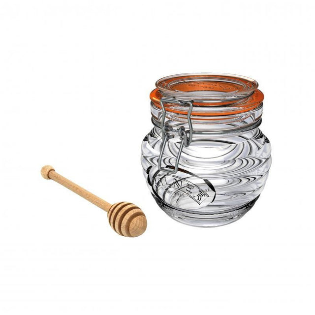 Elegant glass honey pot with embossed beehive design, airtight seal, and beechwood dipper for stylish serving.