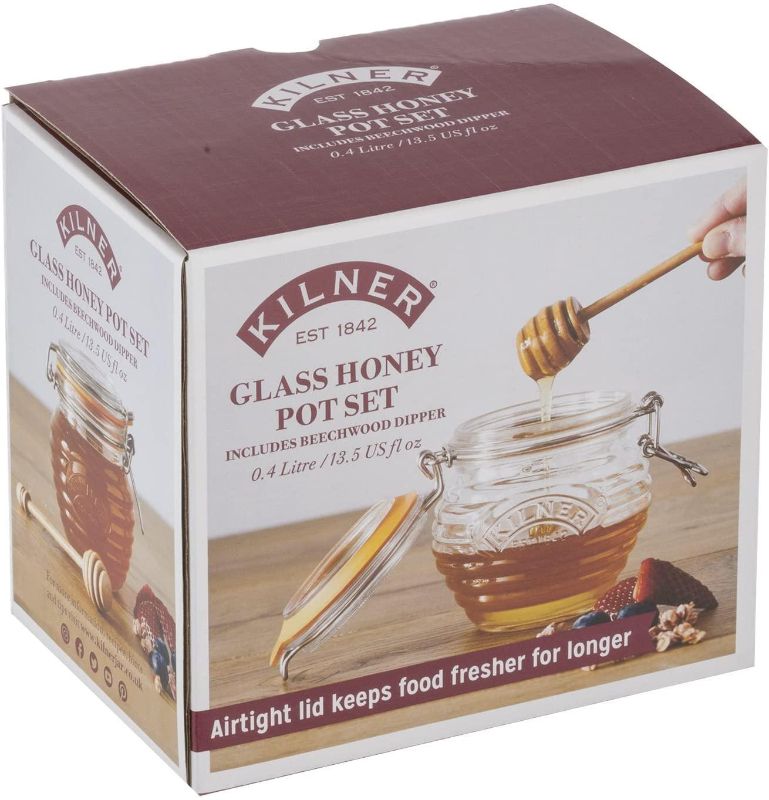 Kilner Honey Pot with embossed beehive design, airtight seal, and wooden dipper for serving and storing honey elegantly.