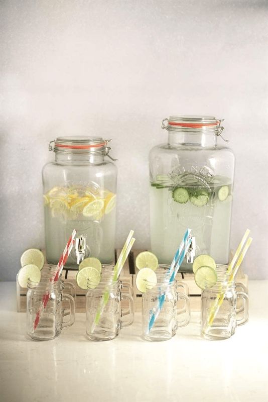 Kilner Round Storage Jar with Dispensing Tap, an 8-liter glass jar with airtight seal, ideal for serving cold beverages at events.