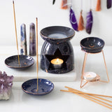 Purple star sign oil burner with gold accents on a metal base, perfect for creating a celestial-themed ambiance.