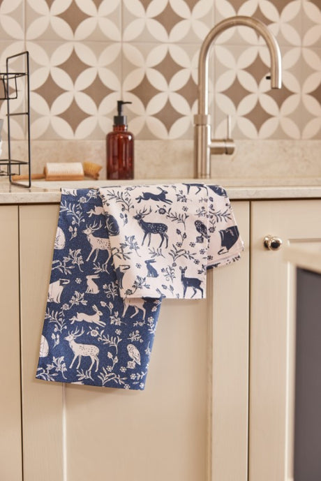 Navy cotton tea towels featuring charming woodland animals on a playful background, eco-friendly and practical for your kitchen.