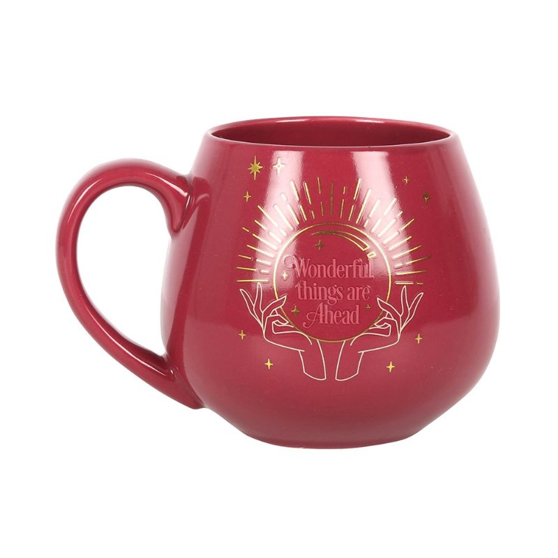 Pink mug with a color-changing design revealing a crystal ball and hidden message, perfect for warm beverages and whimsy.