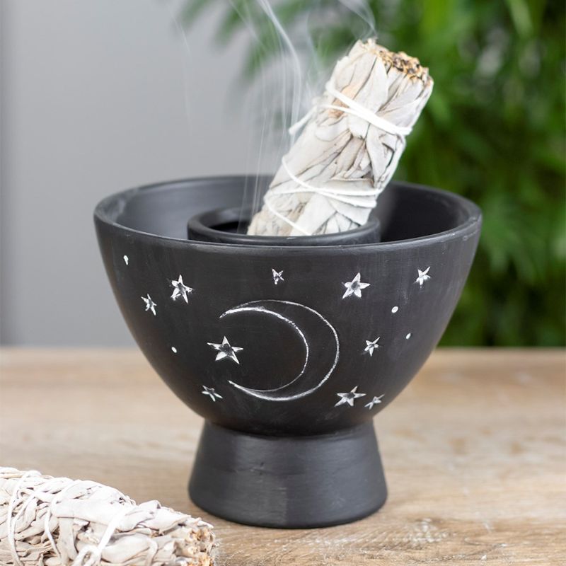 Black terracotta smudge bowl featuring crescent moon and stars design, ideal for burning herbs and decorating spiritual spaces.