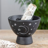 Black terracotta smudge bowl featuring crescent moon and stars design, ideal for burning herbs and decorating spiritual spaces.