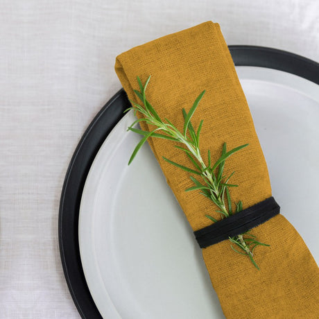 Set of 4 Oak-colored 100% linen napkins, crafted for elegance and durability, perfect for any dining occasion.