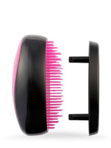 Compact detangling brush with Flexi-Guide tech for gentle, effective detangling on all hair types, perfect for on-the-go use.