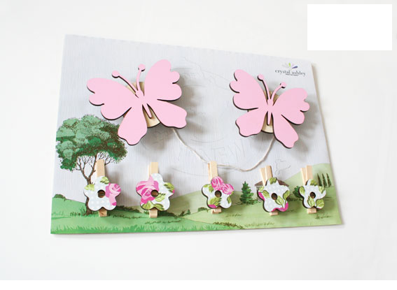 Pink butterfly wall art pegs for displaying children's artwork, creating a whimsical gallery in their bedroom or playroom.