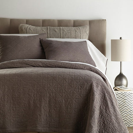 Charcoal queen quilt featuring a diamond and square grid pattern, crafted from premium cotton for comfort and elegance.