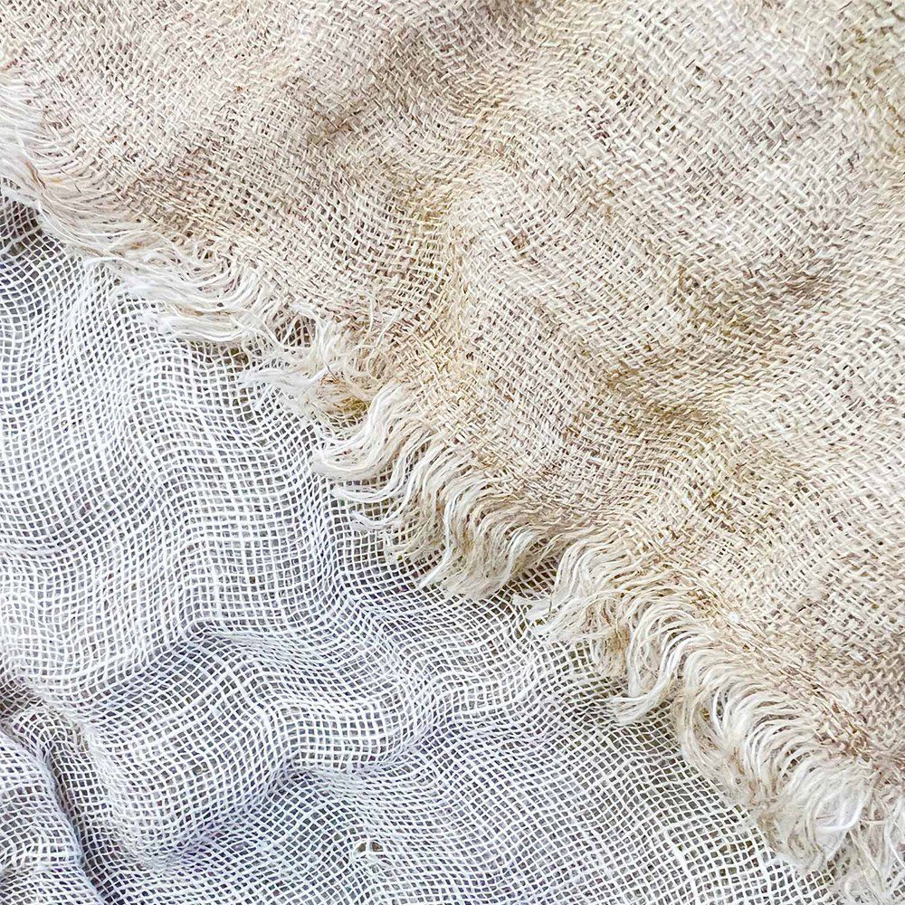 Sophisticated 100% linen KENT Natural throw in two-tone, featuring a chic distressed eyelash edge, measuring 125 x 150cm.