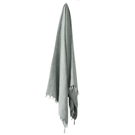 Light mist-colored linen throw with fringe detailing, measuring 130 x 170 cm. Perfect for adding vintage charm to any space.