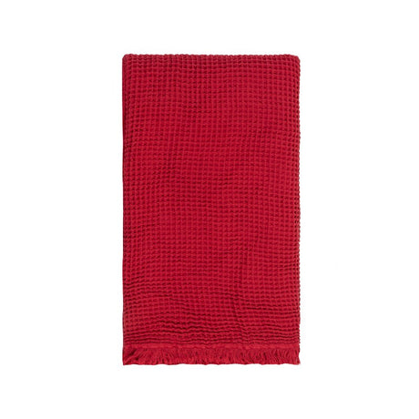 Vibrant red waffle throw made from 100% cotton, perfect for adding warmth and style to your home decor.