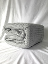 Grey King-sized Bamboo Blend Waffle Blanket with plush Sherpa backing, offering softness and warmth for cozy relaxation.