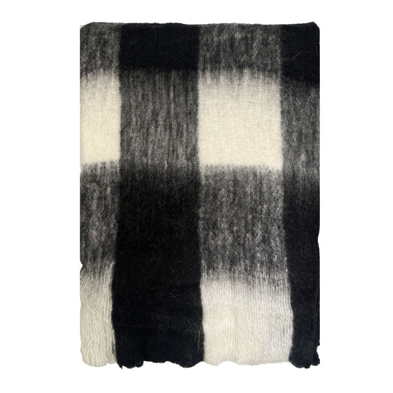 Luxurious black and white check throw made of wool-mohair blend, featuring eyelash fringe for elegance, perfect for cozy decor.