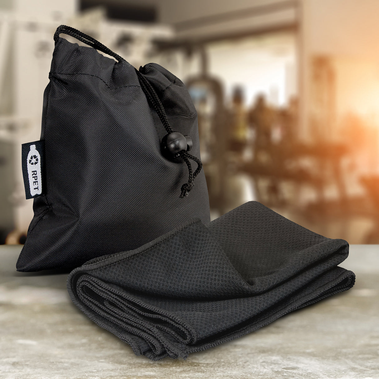 Black eco-friendly cooling towel made from RPET, perfect for outdoor activities; activates with water to cool instantly.