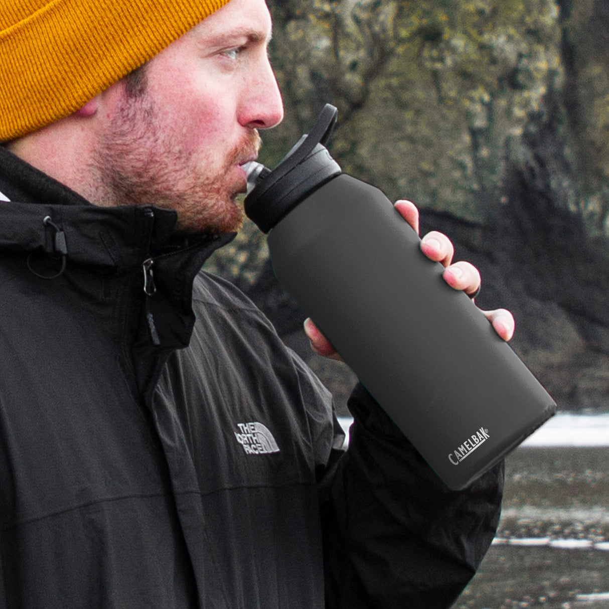 CamelBak Eddy 1L Vacuum Bottle in black, insulated for hot or cold drinks with a spillproof flip valve and sturdy carry handle.
