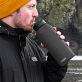 CamelBak Eddy 1L Vacuum Bottle in black, insulated for hot or cold drinks with a spillproof flip valve and sturdy carry handle.