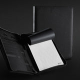 Elegant black A5 portfolio with zipper, featuring a notepad, phone stand, card slots, and a luxurious 3D Swiss Peak badge.