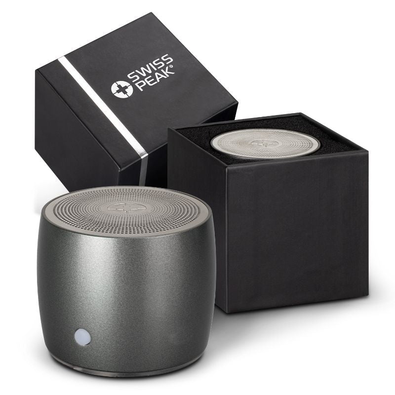 Compact black Swiss Peak Bass Speaker with 3W output, optimal bass, durable stainless steel, and 5-hour battery life.